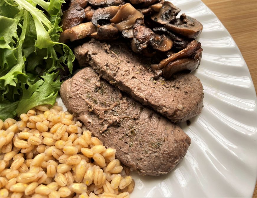 Close up of vension steak with mushrooms