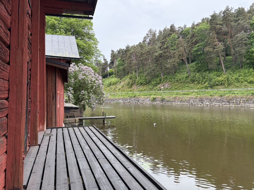 View of river from the deck of a red wooden building