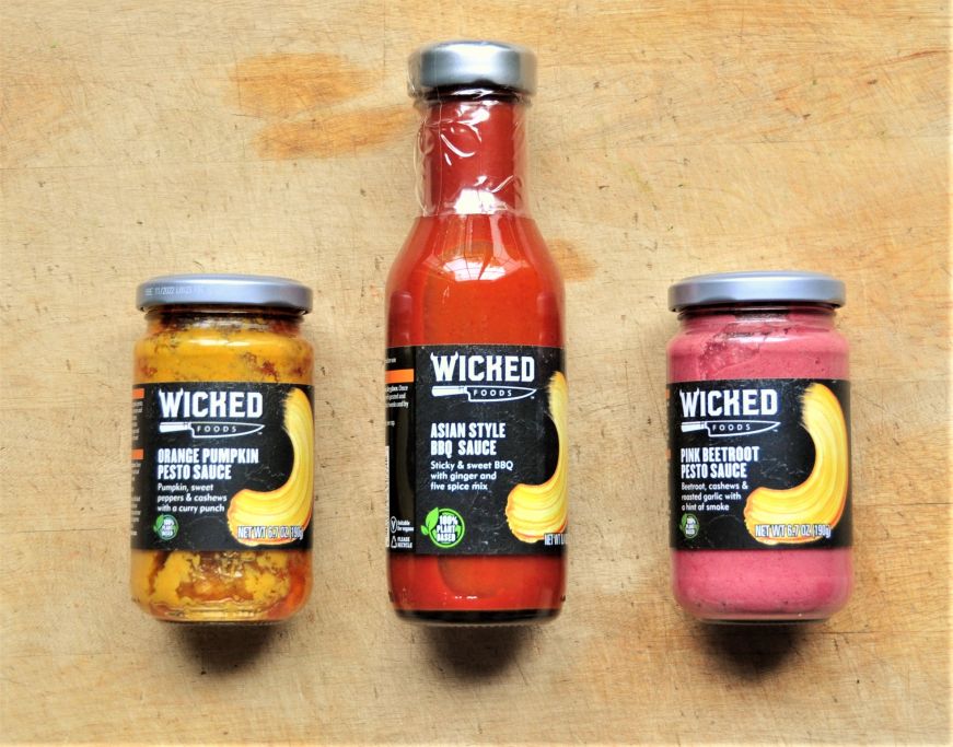 Two jars of pesto and a bottle of barbecue sauce