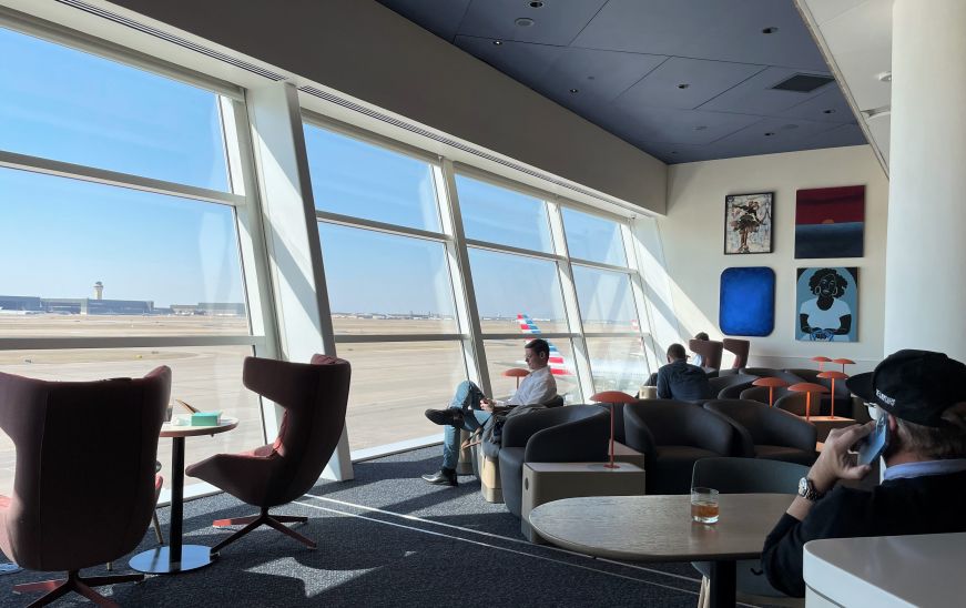 Seating area by windows overlooking airport runway