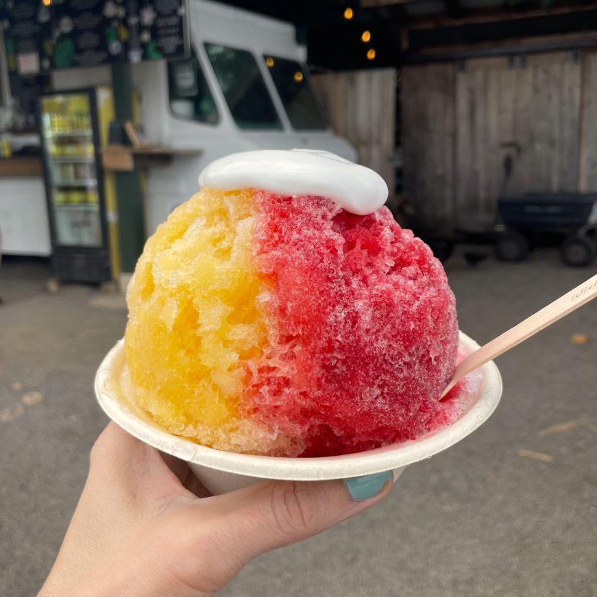 Wishing Well Shave Ice, Hanalei Stacy's hand holding a cup of shave ice