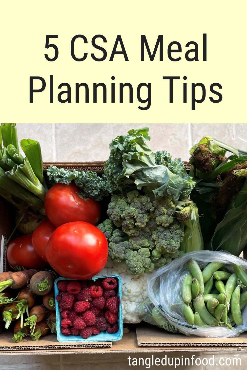 Cardboard box of produce with text reading "5 CSA meal planning tips"