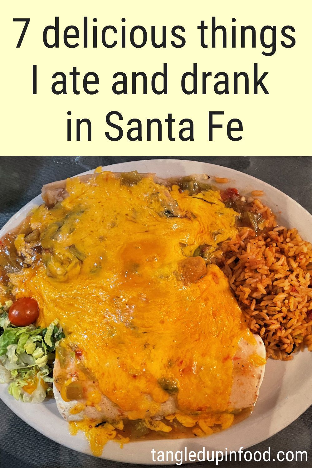 PLate of food covered with cheese and text reading "7 delicious things I ate and drank in Santa Fe"