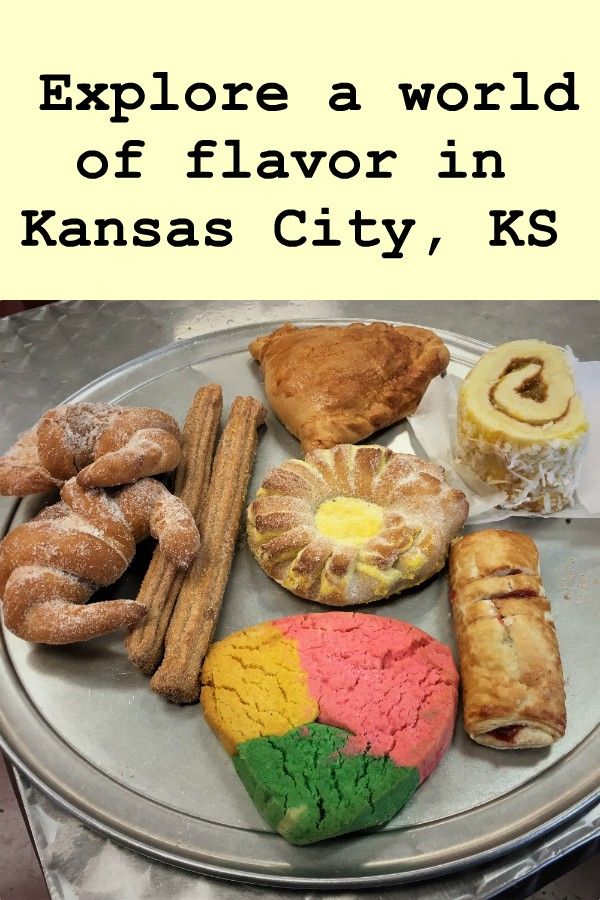 Assortment of colorful Mexican pastries on a metal tray with text "Explore a world of flavor in Kansas City, KS"