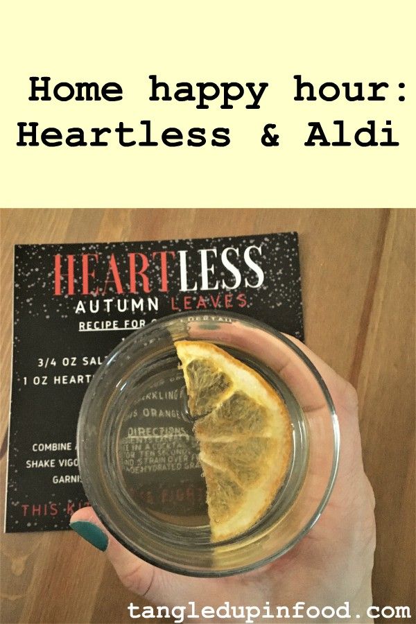 Hand holding cocktail with text reading "Home happy hour: Heartless & Aldi" 
