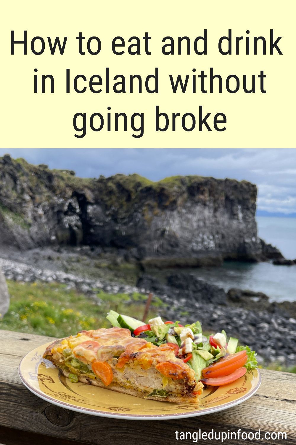 Photo of a quiche with a scenic seaside view in the background with text reading "How to eat and drink in Iceland without going broke"