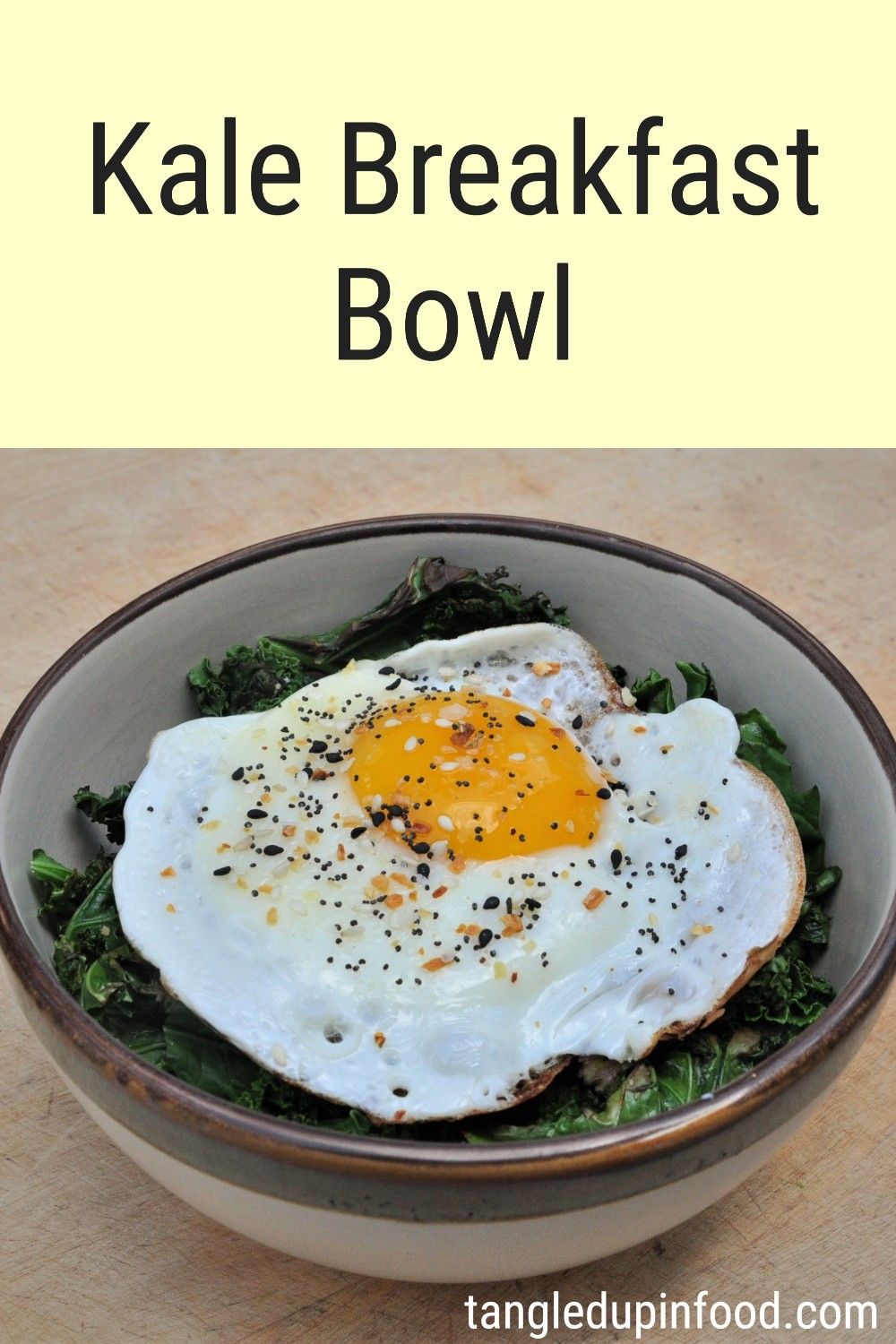 Bowl filled with sauteed kale and topped with a fried and text reading "Kale Breakfast Bowl"