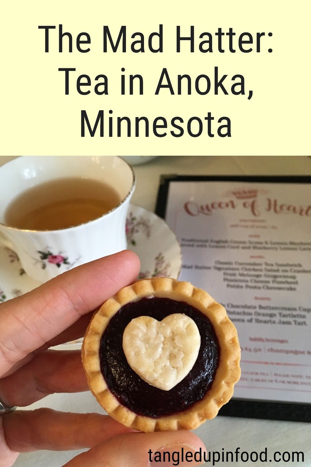 Hand holding miniature jam tart with text reading "The Mad Hatter: Tea in Anoka, Minnesota"