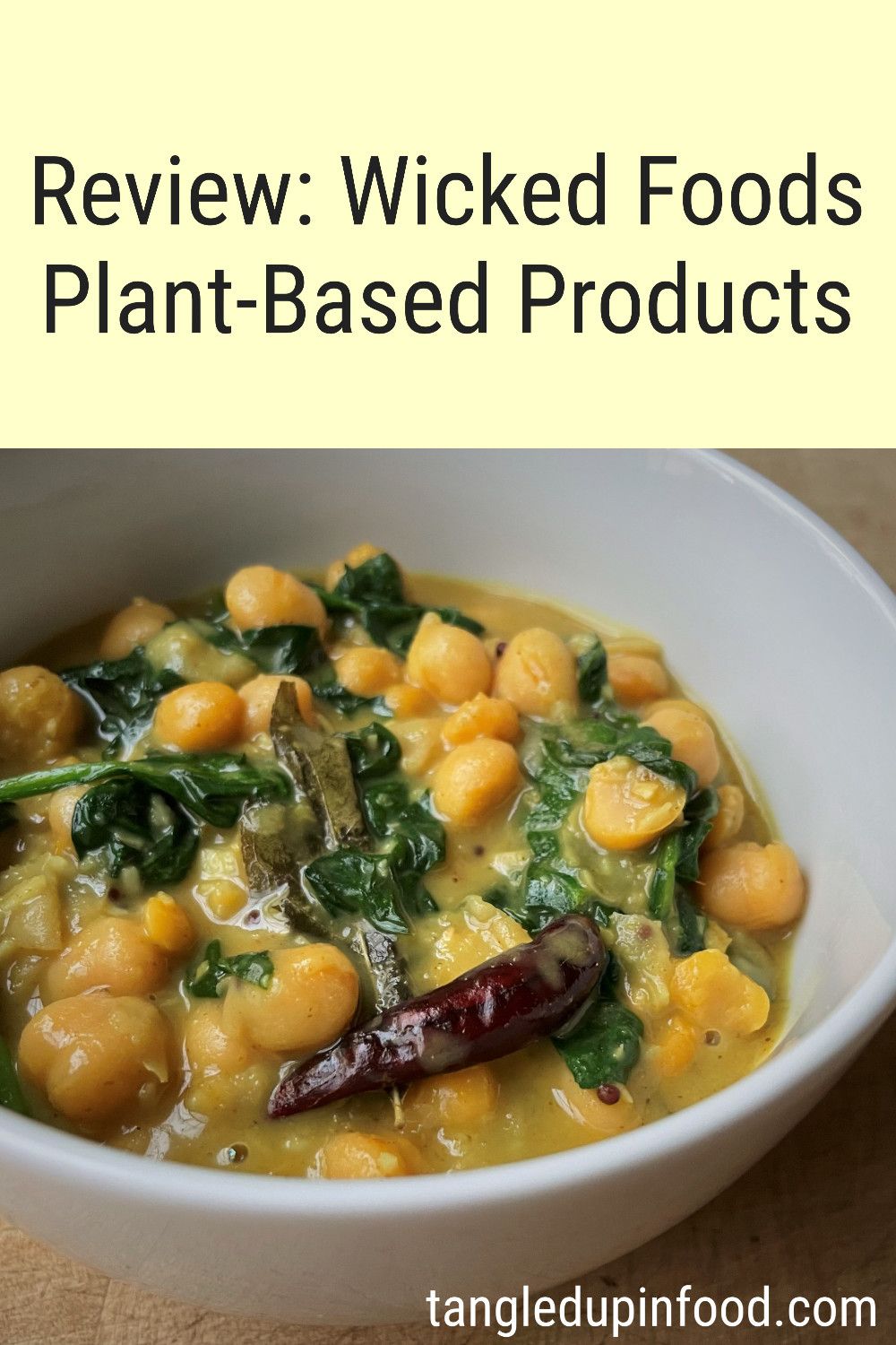 Picture of bowl filled with chickpeas and spinach in a yellow sauce and text reading "Review: Wicked Kitchen Plant-Based Products"
