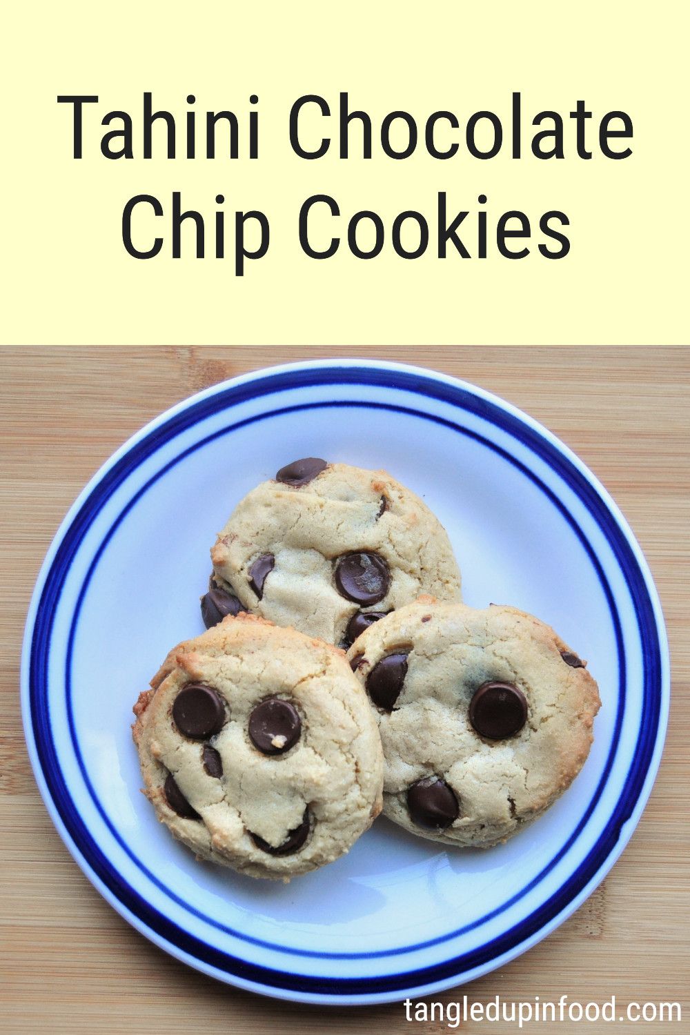 Photo of three cookies on a plate with text reading "Tahini Chocolate Chip Cookies"