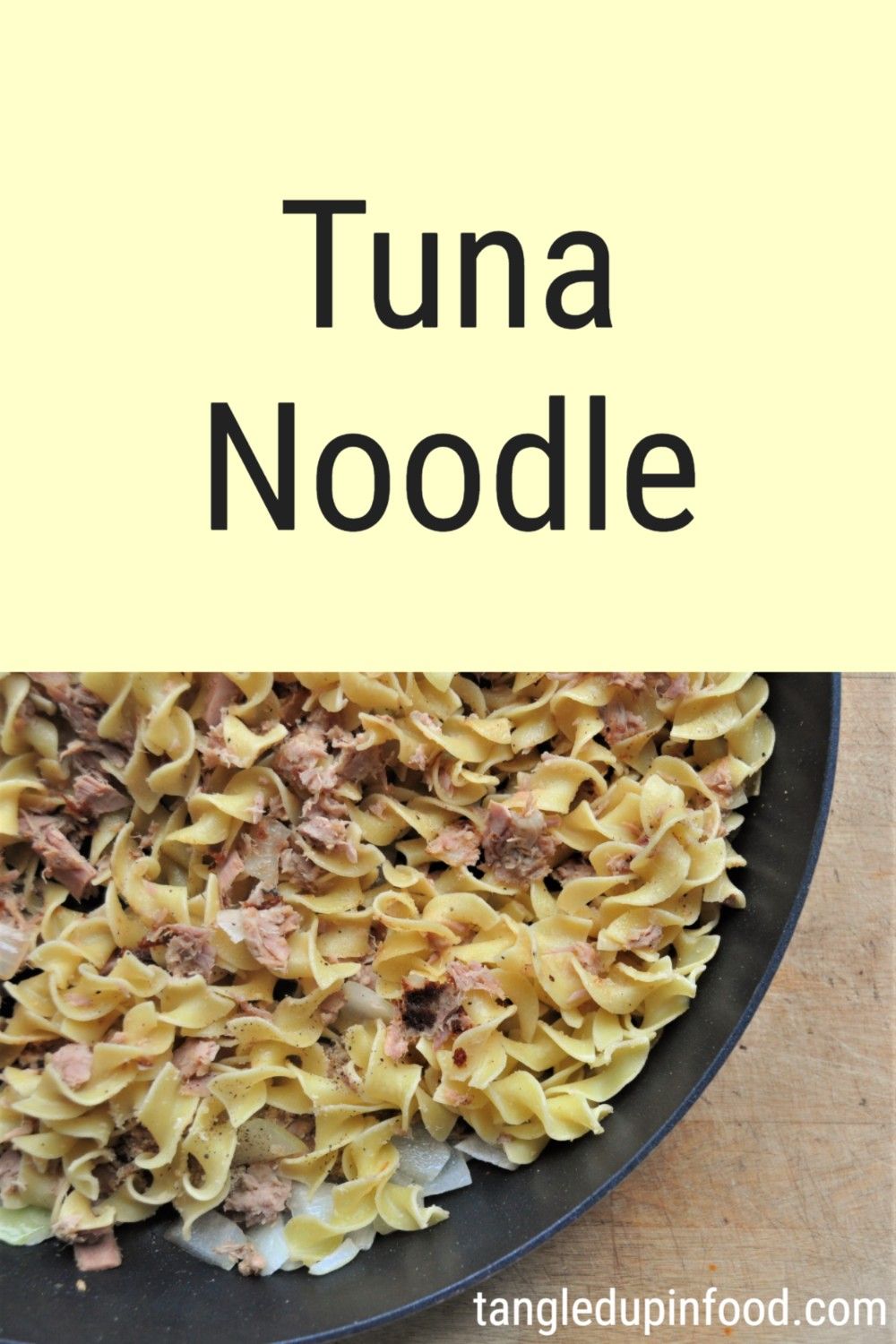 Egg noodles and tuna in skillet with text reading "Tuna Noodle"