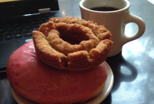 The tools of a food blogger's craft: doughnuts, coffee, and a laptop