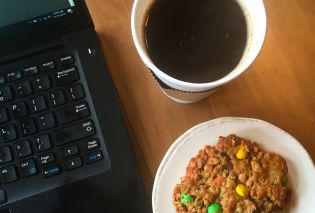 Top down view of laptop keyboard, coffee, and oatmeal M&M cookie, The Wired Robin, Hudson
