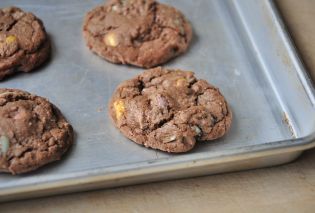 Chocolate Cadbury Mini Egg cookies on a baking sheet