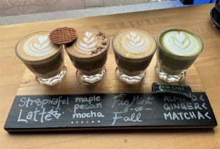 Four glasses of coffee with latte art