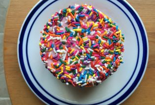 Individual sized cake covered with sprinkles