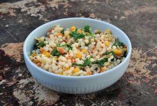 Bowl filled with cooked Harvest Grains Blend with parsley and grated parmesan