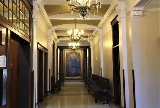 Hallway with crystal chandeliers and oil painting