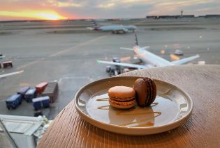 Plate of macarons with sunset and airport runway in the background