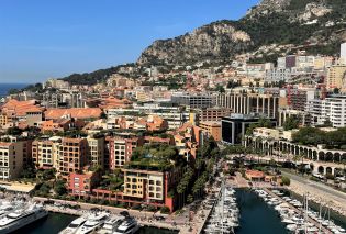 Steep hillside covered with high rises with a port at the bottom