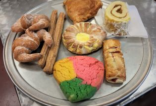 Round metal tray with an assortment of colorful Mexican pastries, Pastries Michoacan Bakery Kansas City Kansas