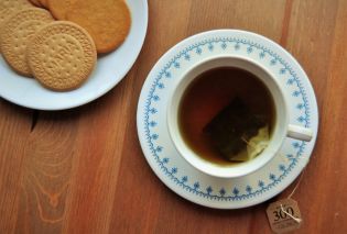 Tea cup with plate of cookies