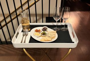 Tray with wine glasses, carafe of white wine, and tray of antipasti
